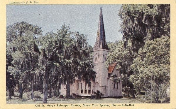 Old St. Mary's Episcopal Church in Green Cove Springs, Florida, surrounded by trees, with a tall steeple.