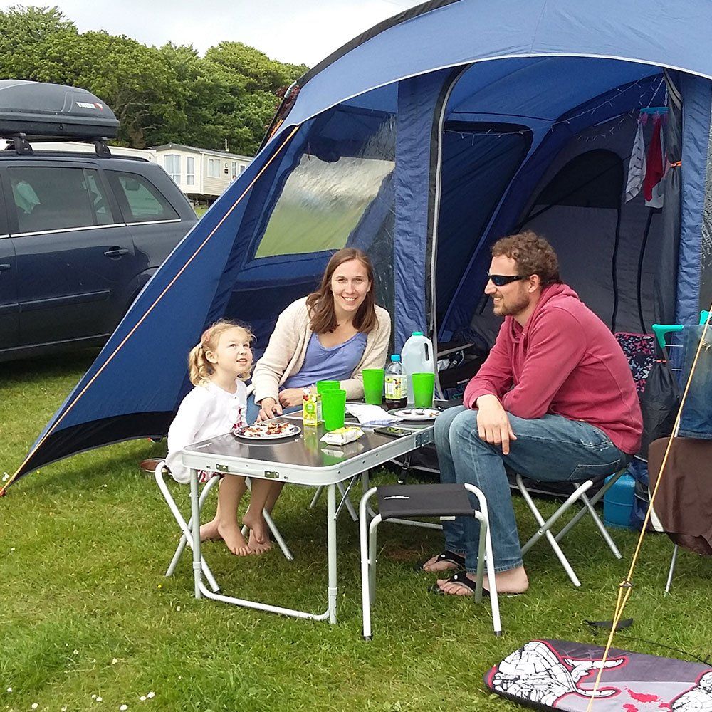 Family enjoying the sun outside their tent at Pennymoor Caravan and Camping Site, Modbury