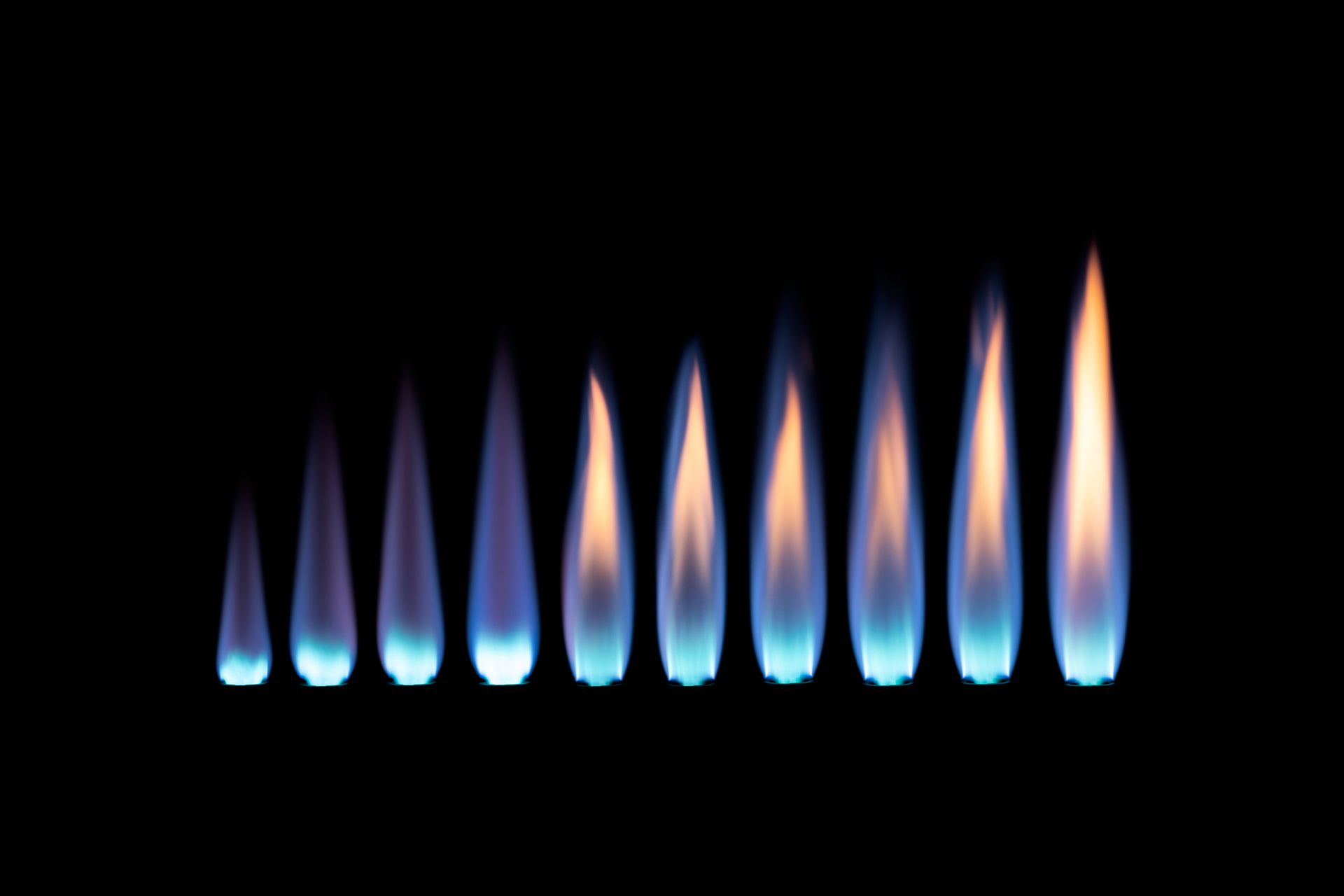 A row of blue flames on a black background.
