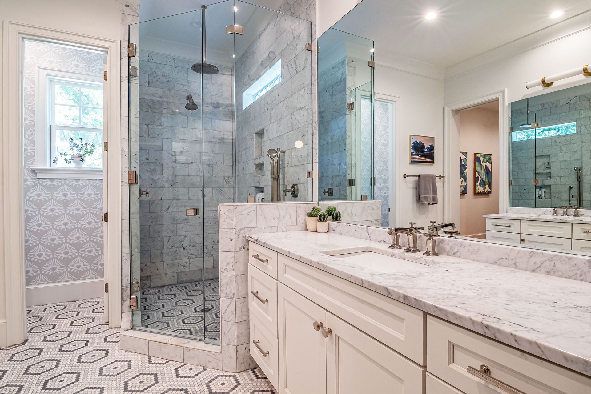 Modern bathroom with double vanity, circular mirrors, walk-in shower, and freestanding bathtub.