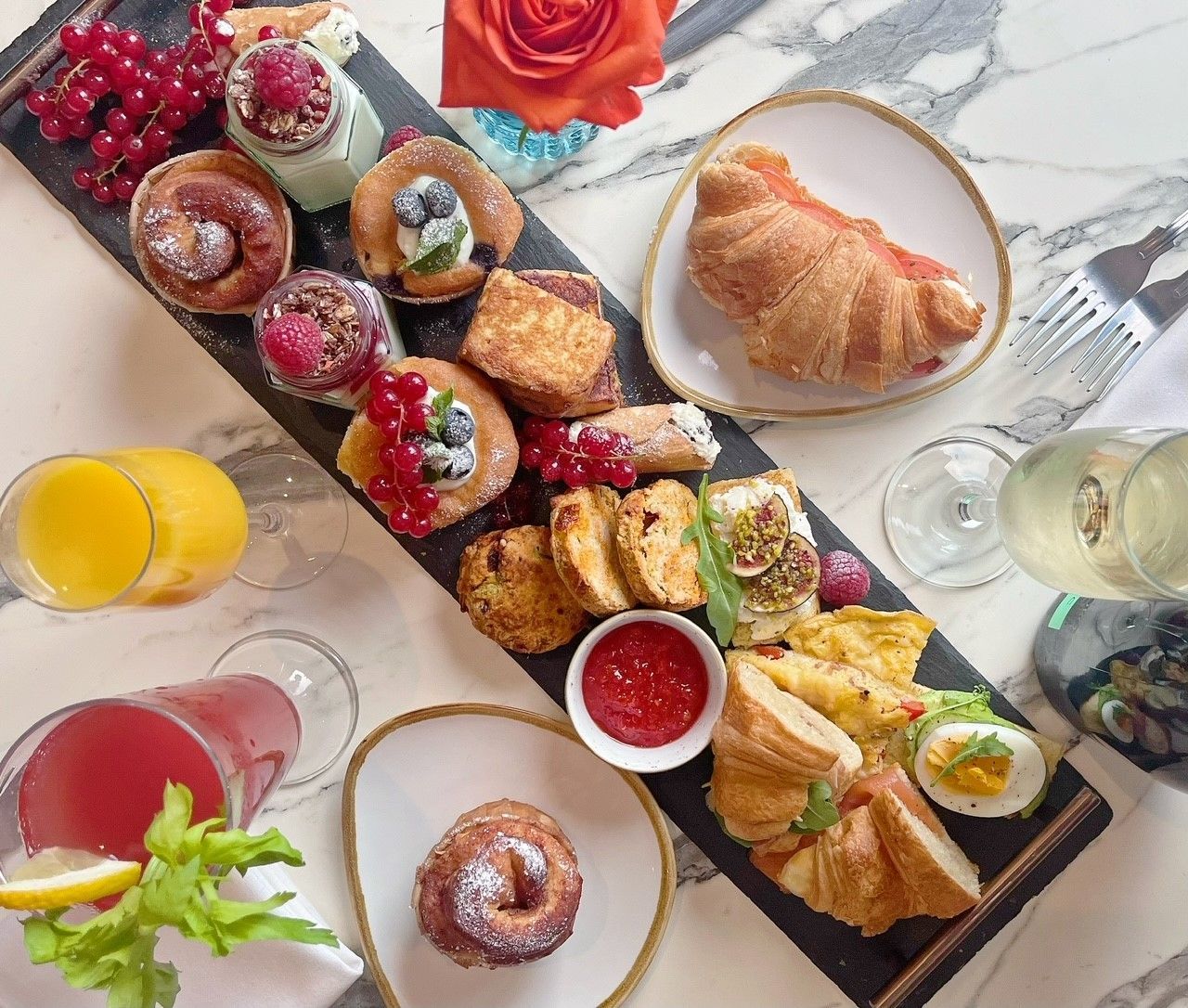 A table topped with a variety of food and drinks.