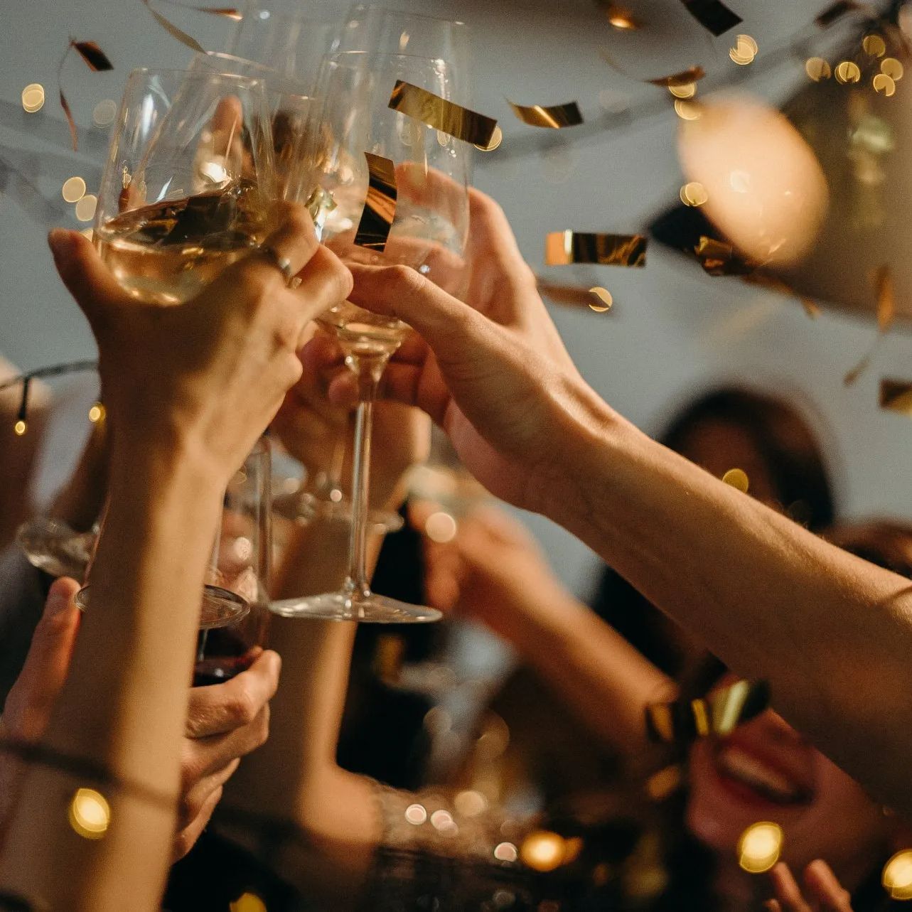 A group of people are toasting with champagne glasses at a party.