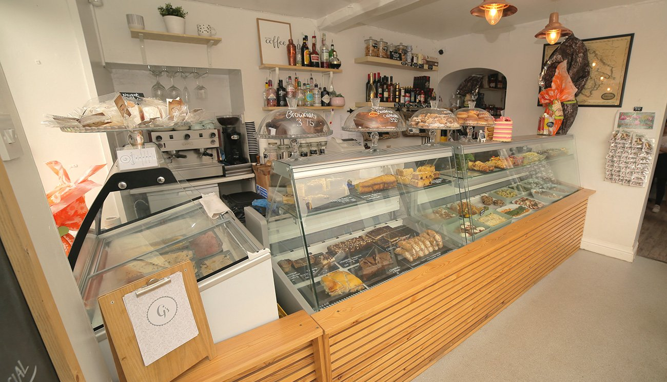 Gabriella's deli with a large glass display case filled with food.