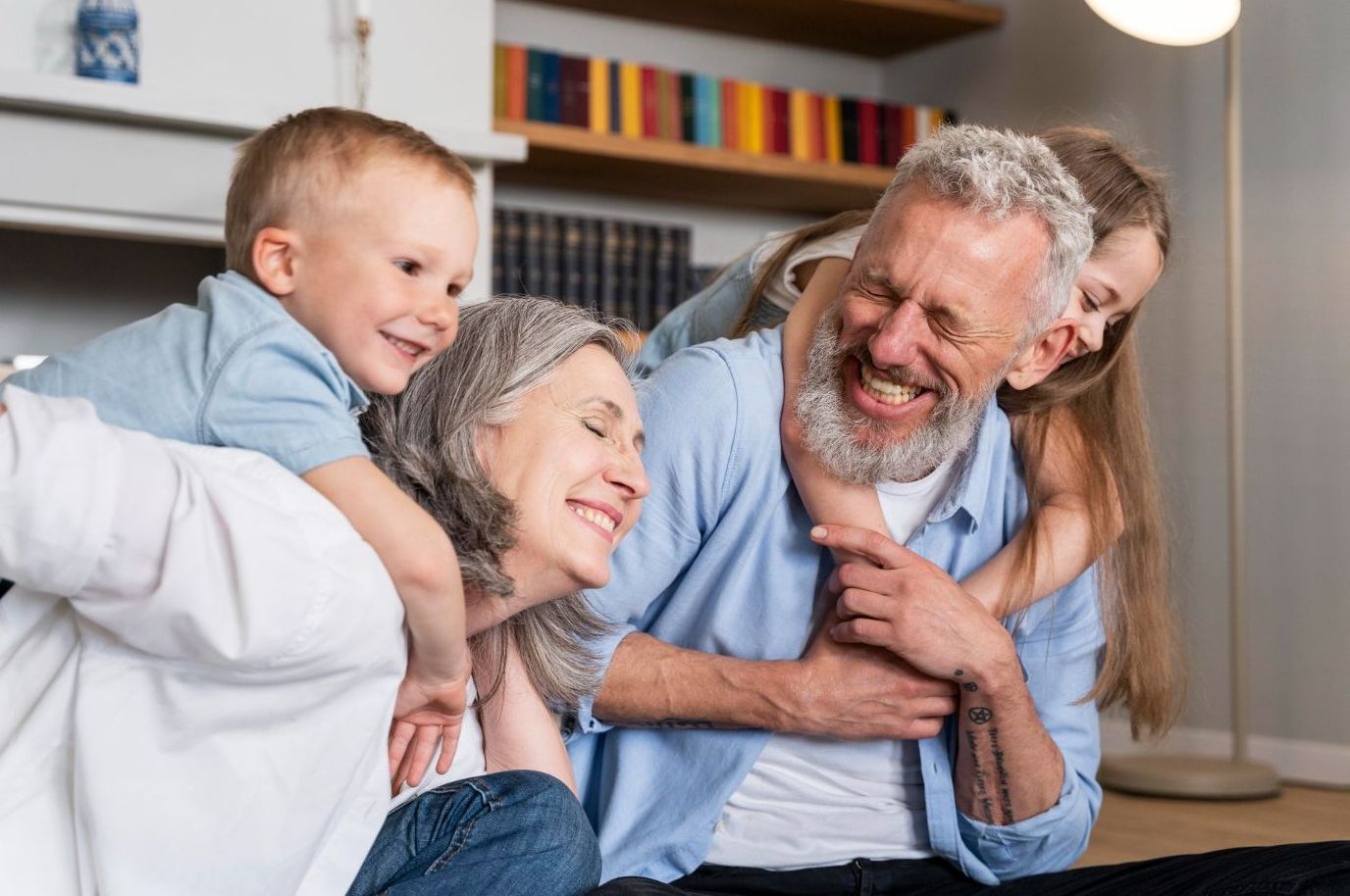 Smiling family hugging on a couch in a bright living room