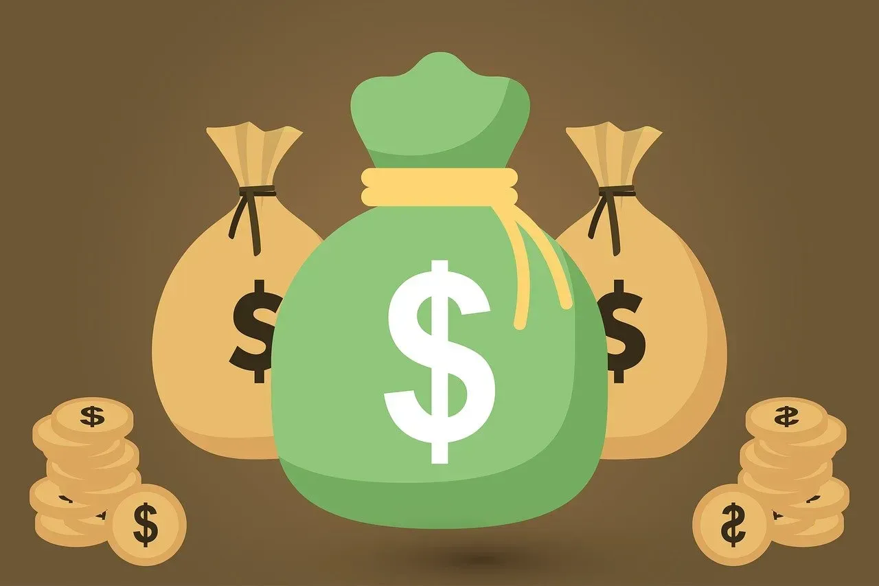 Green money bag with dollar sign, surrounded by gold coin stacks and two tan money bags on a brown background