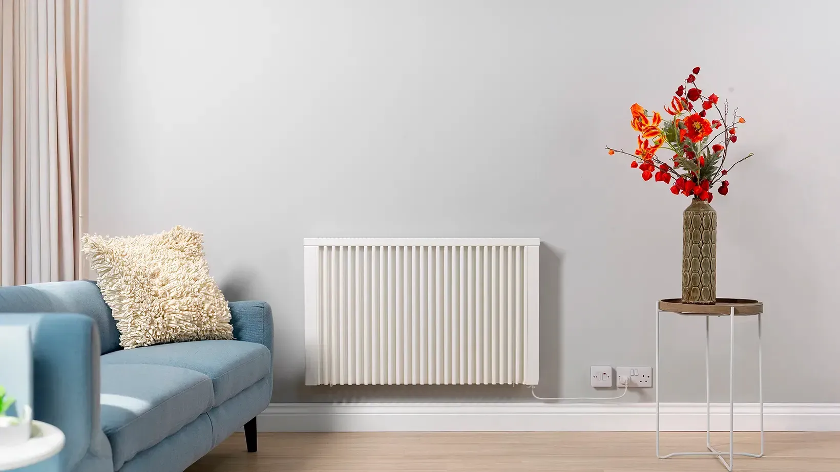 A living room with a white couch and a white radiator