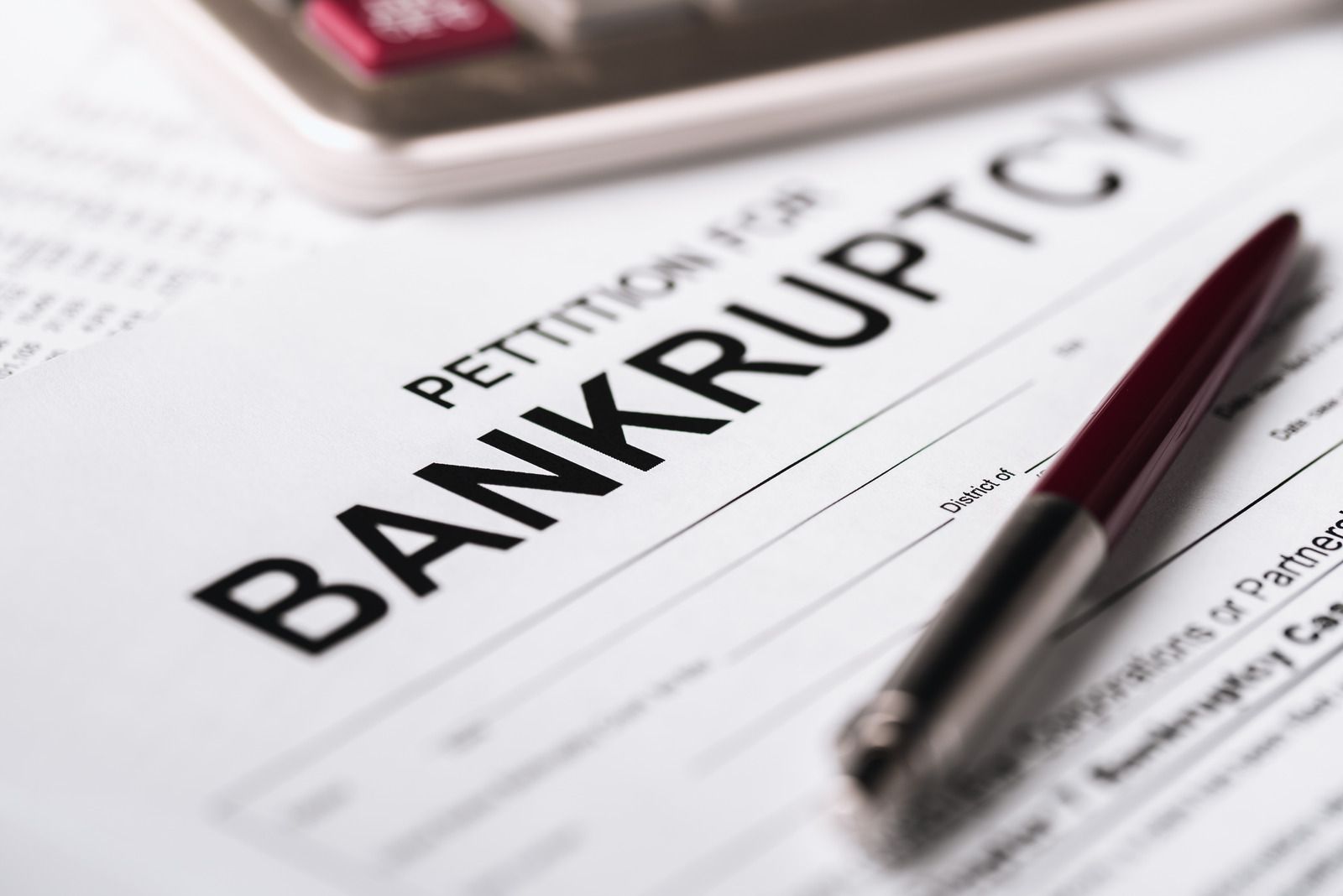 Bankruptcy petition form with a pen on a desk