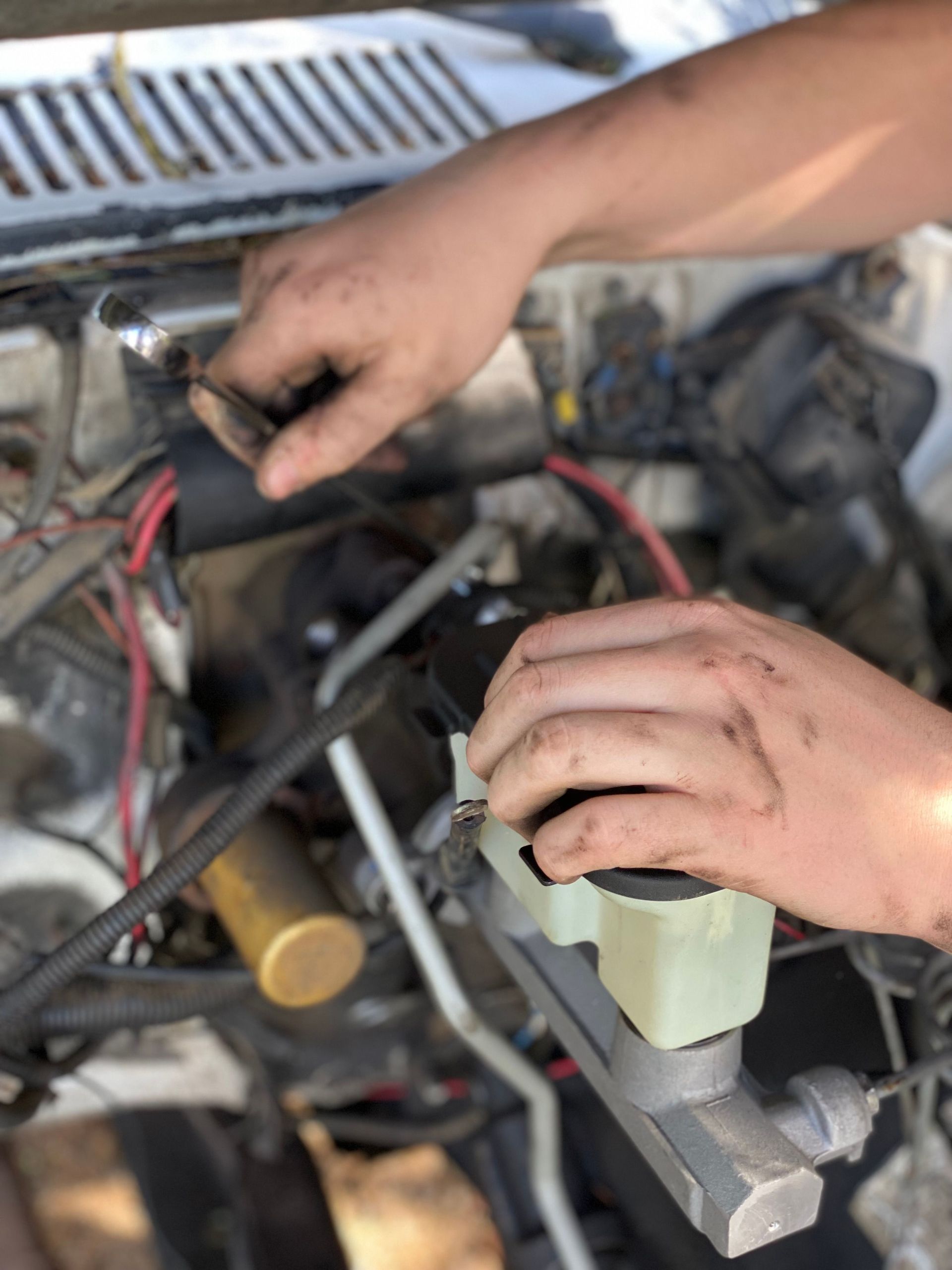 Hands Performing Engine Maintenance Service | Knost Tire & Automotive