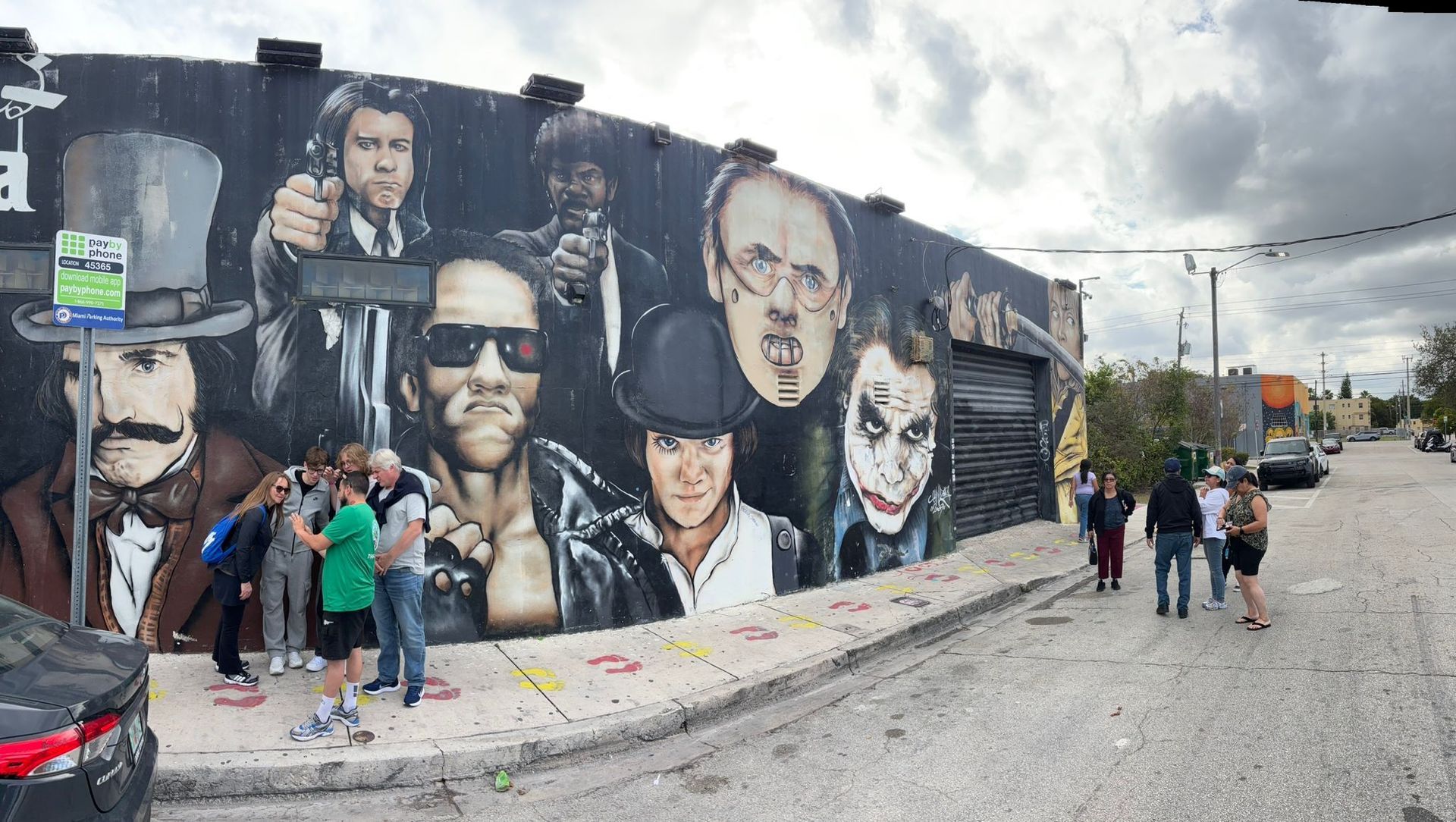Guests enjoying the Wynwood stop with colorful murals as the backdrop