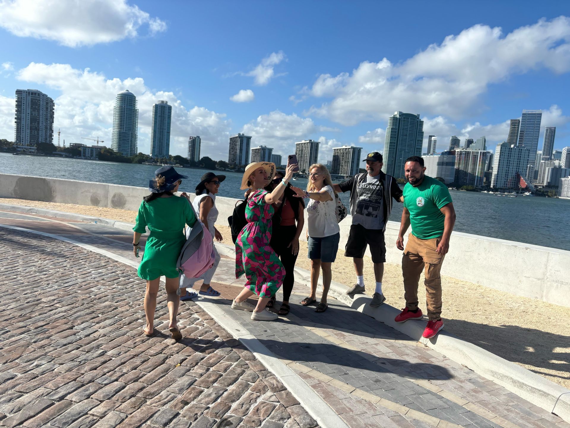 Passengers taking photos with tour Guide in the Secret Miami Skyline photo spot, on the 4 stop city tour in Miami