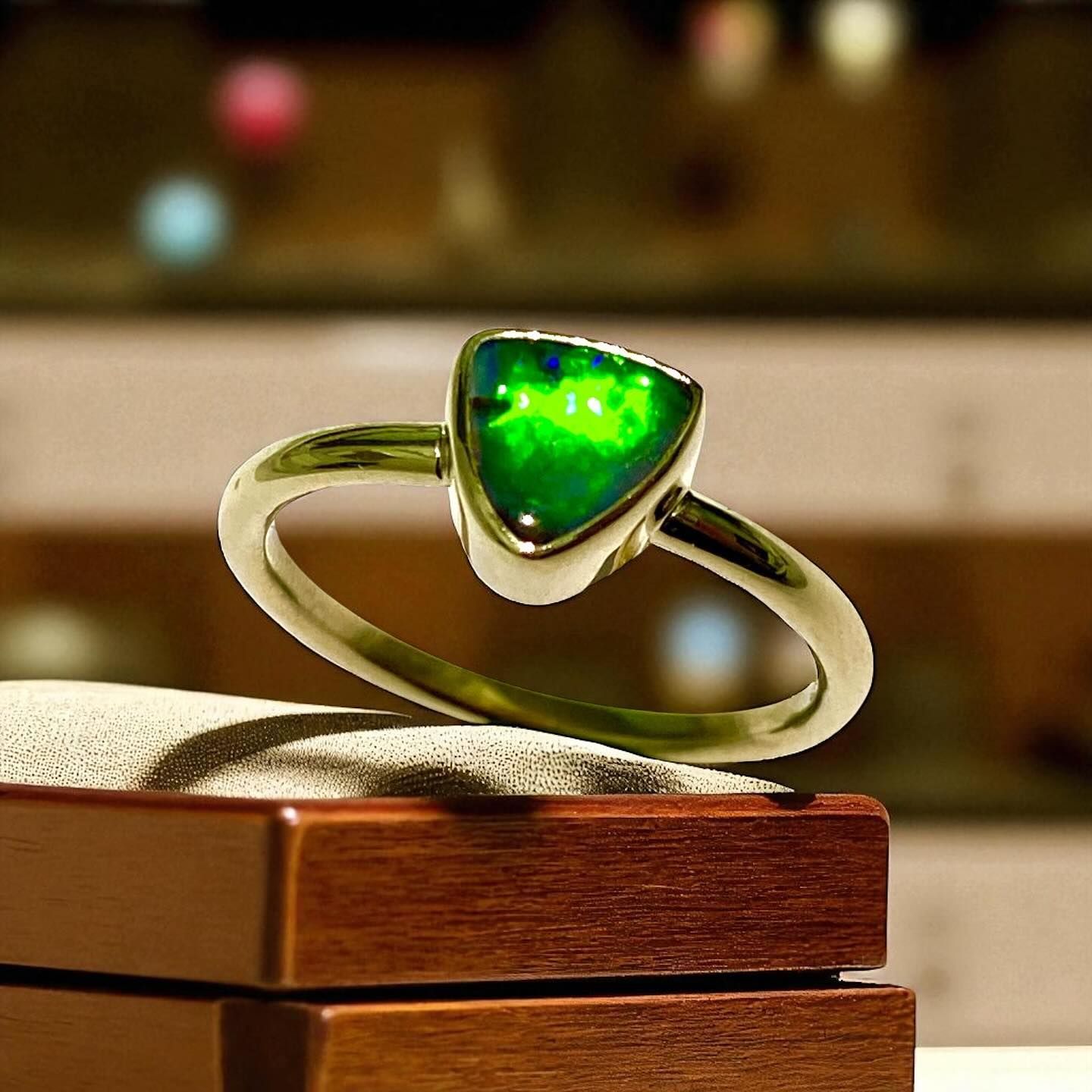 Green Opal Ring, Triangular Stone in a Gold Setting, Resting on a Wooden Box — Regency Jewellers in Cairns City, QLD