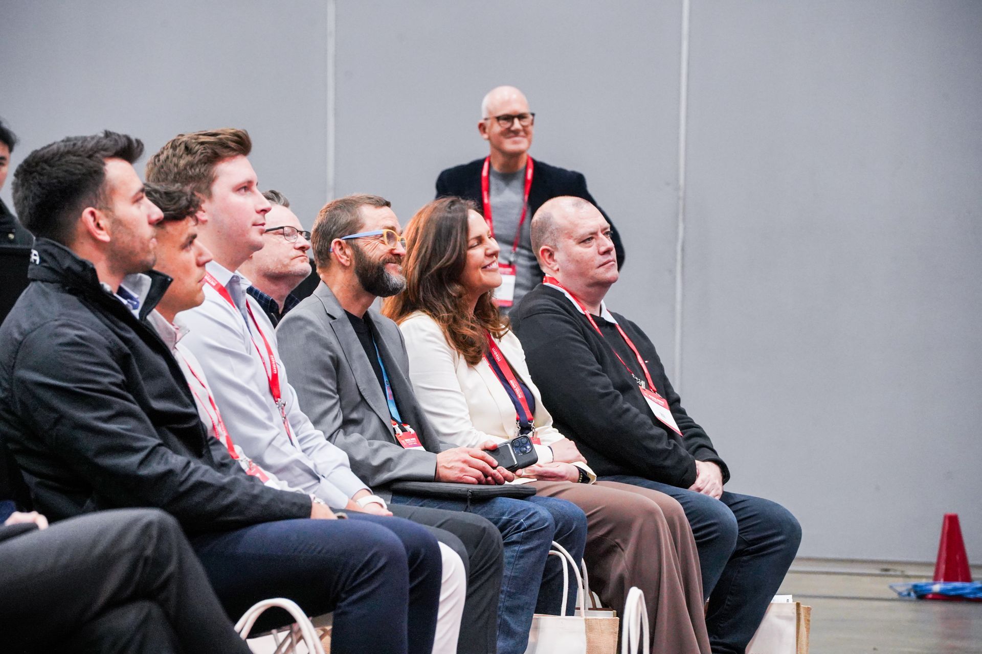 Audience seated in chairs listening attentively at an event
