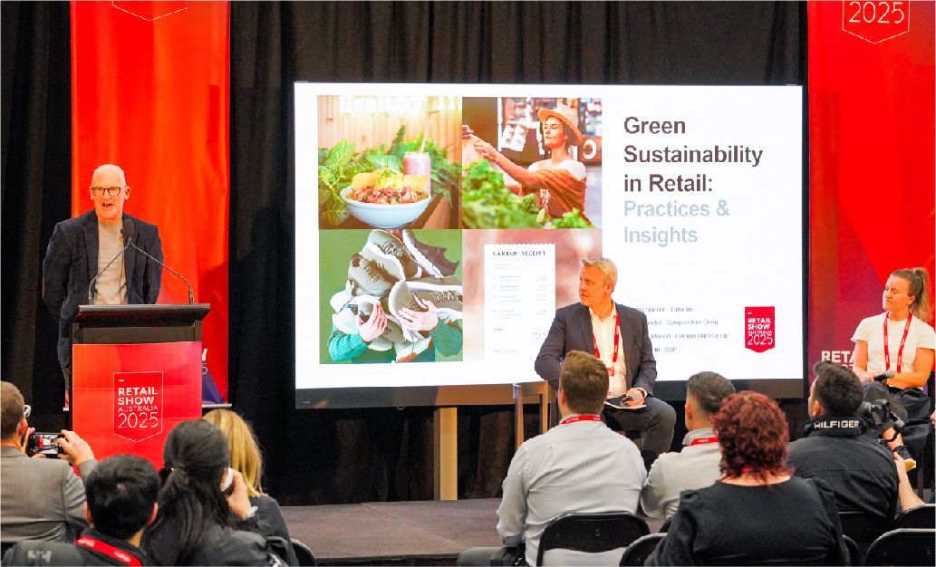 Panel discussion on green sustainability in Berlin, with speakers on stage and presentation slide
