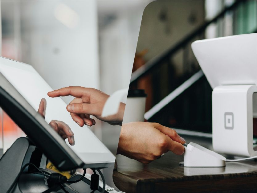 Hands using a touchscreen payment terminal at a checkout counter