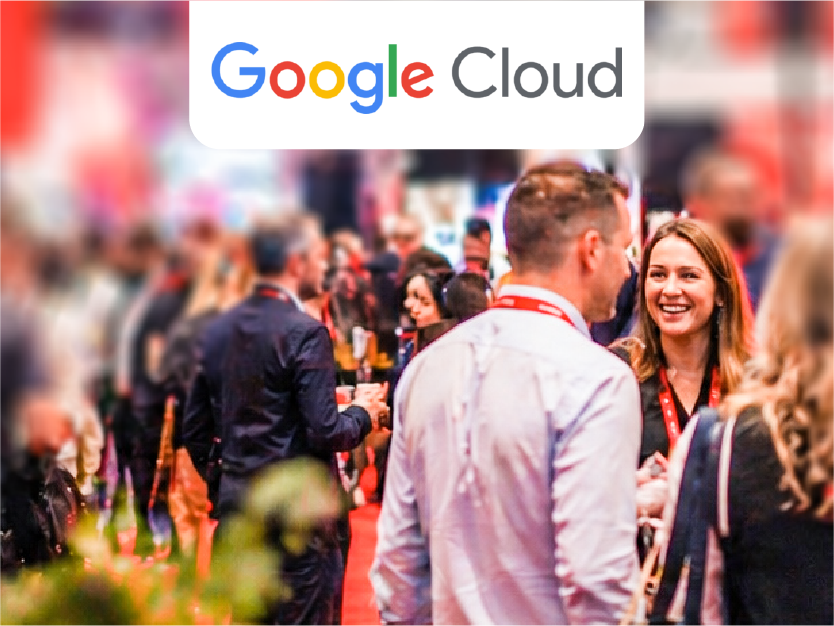 Google Cloud logo over a blurred crowd at a tech conference booth