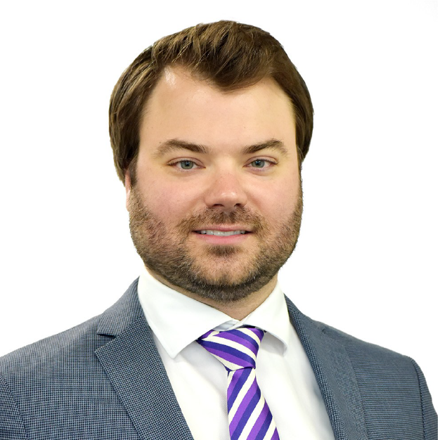 Portrait of a smiling man in a gray suit with a purple striped tie on a white background