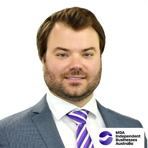 Portrait of a man in a gray suit and purple striped tie on a white background, with the MGA Independent Business Association logo.