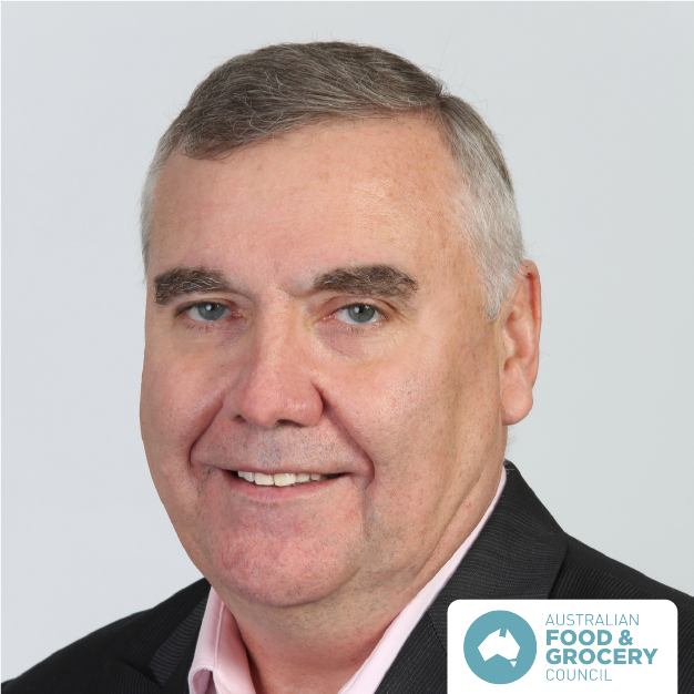 Headshot of a man in a dark suit smiling against a light background, with an Australian Food & Grocery logo.