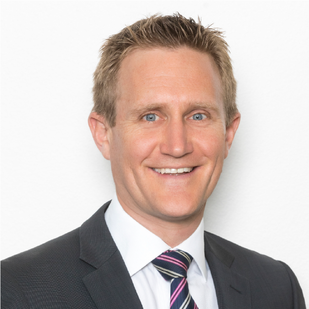 Portrait of a smiling man in a dark suit and striped tie on a white background