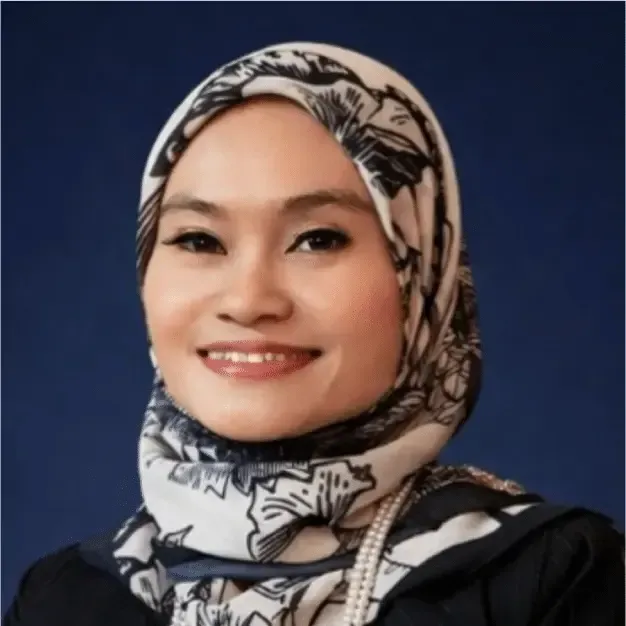 Smiling person in a patterned hijab against a solid blue background