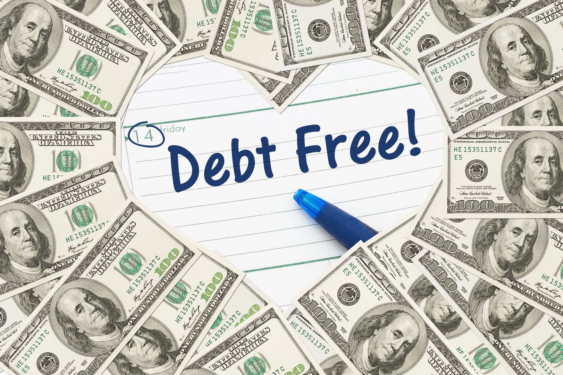 A heart made out of money with the words `` debt free '' written on a piece of paper.