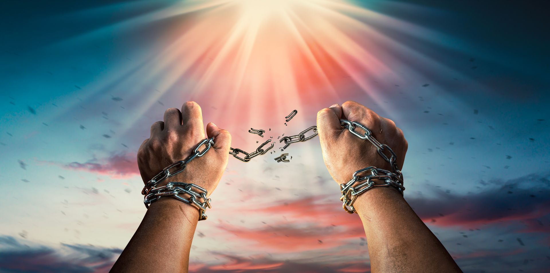 A person is breaking chains in their hands.
