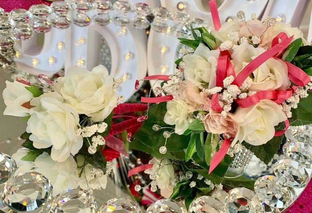 A table with flowers and a sign that says bride on it.