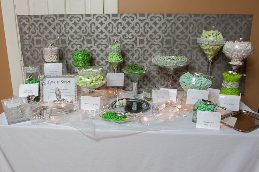A candy bar with green and white candies on a table.