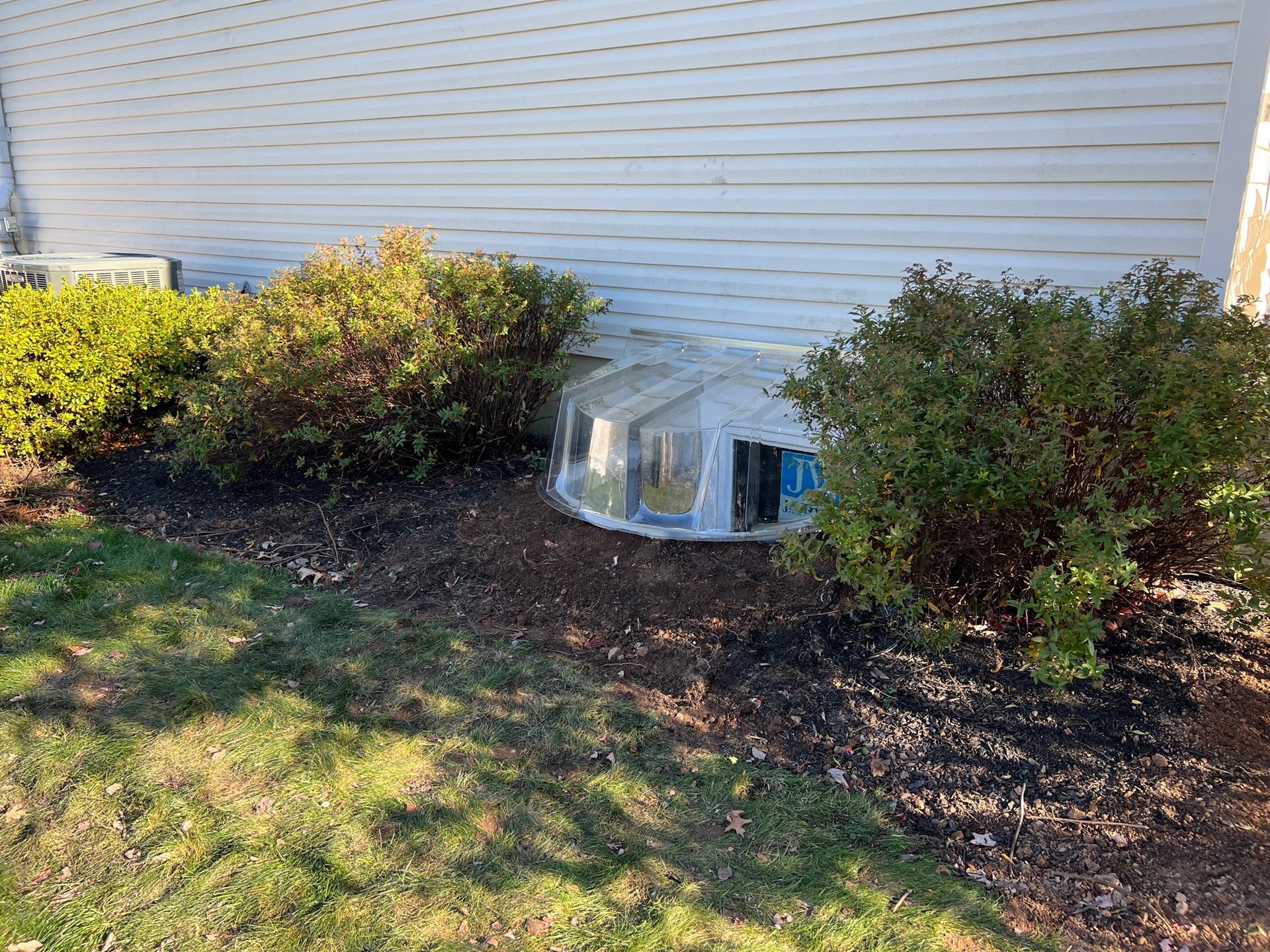 A house with a window cover on the side of it.