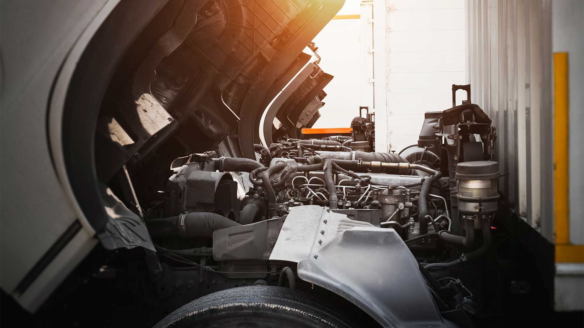 The engine of a truck is shown with the hood open.