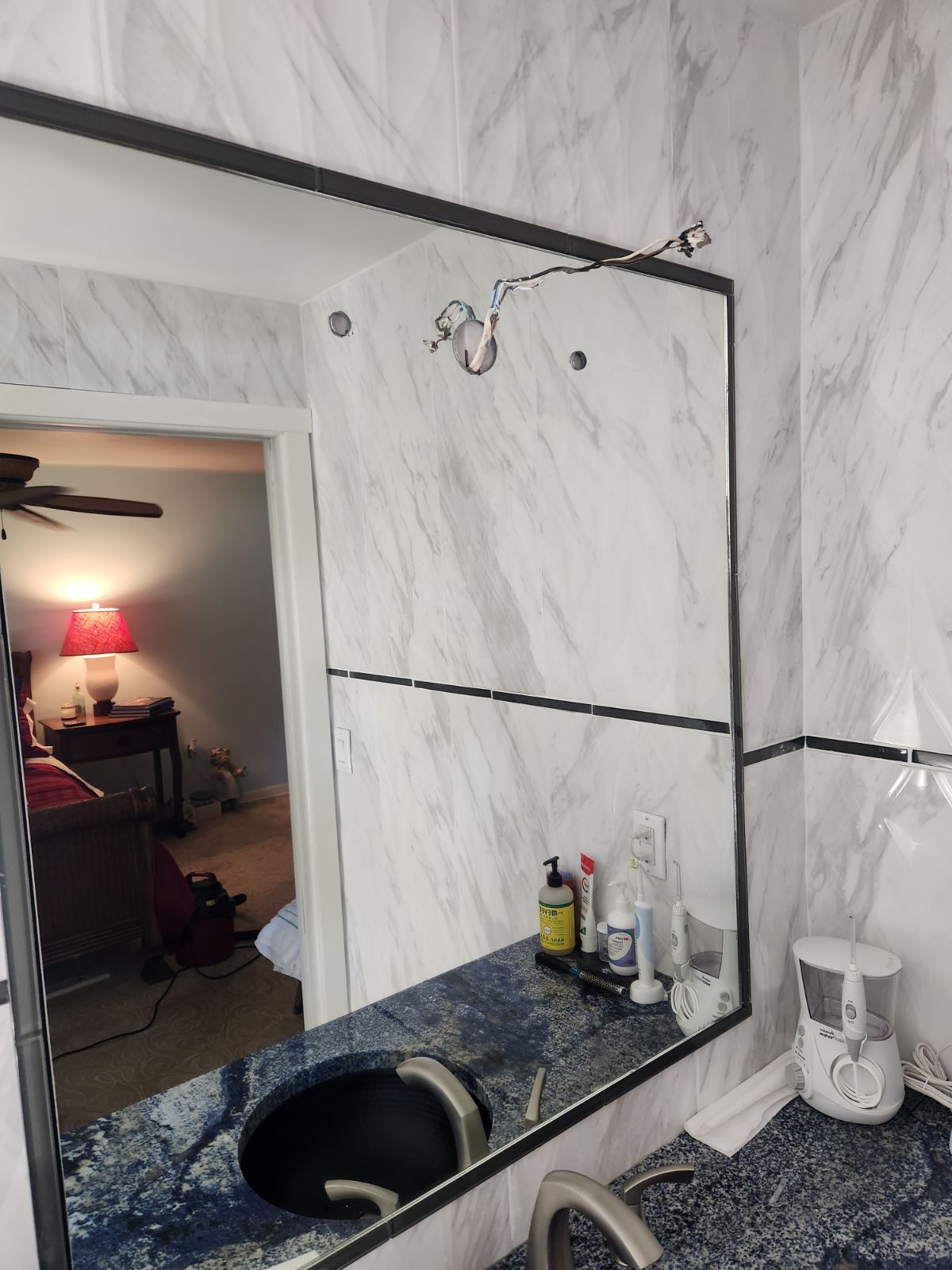 Simple Bathroom mirror replacement with holes for fixtures and outlets.