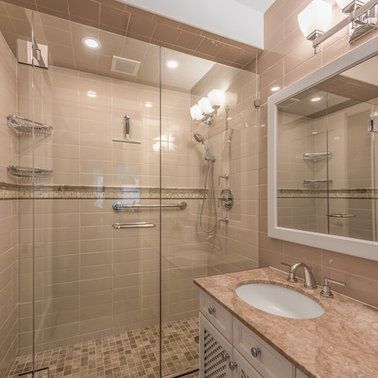 A bathroom with a walk in shower , sink and mirror.