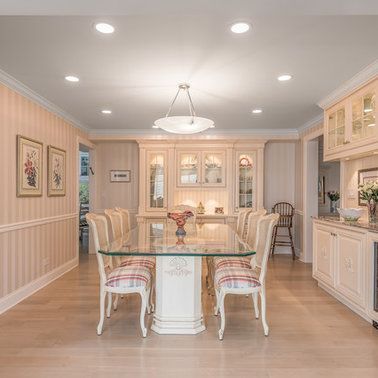 A dining room with a glass table and chairs.