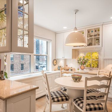 A kitchen with a table and chairs and a window.