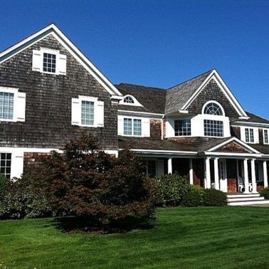 A large house with a lush green lawn in front of it