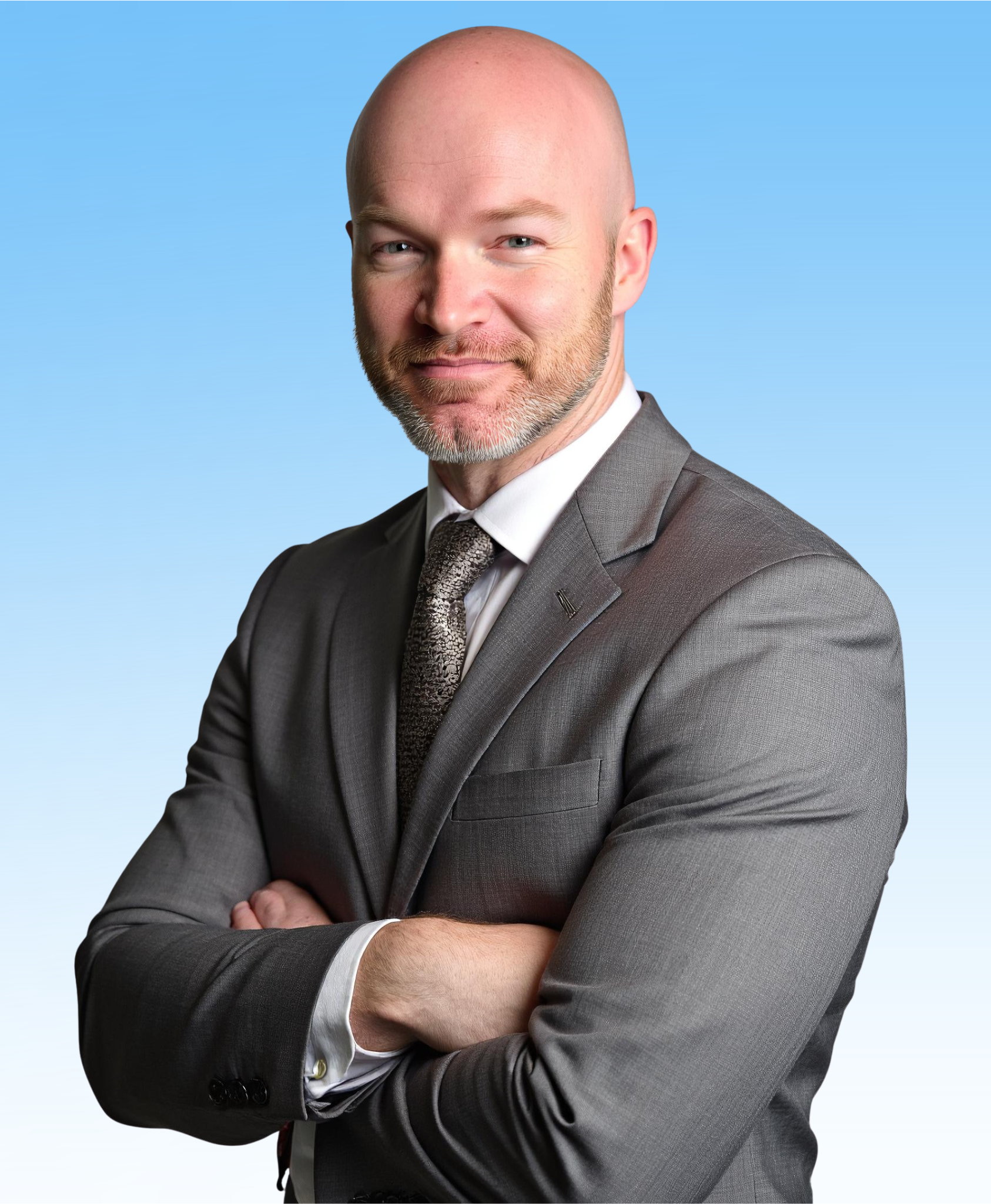 Man in gray suit with arms crossed, standing in front of a blue gradient background.