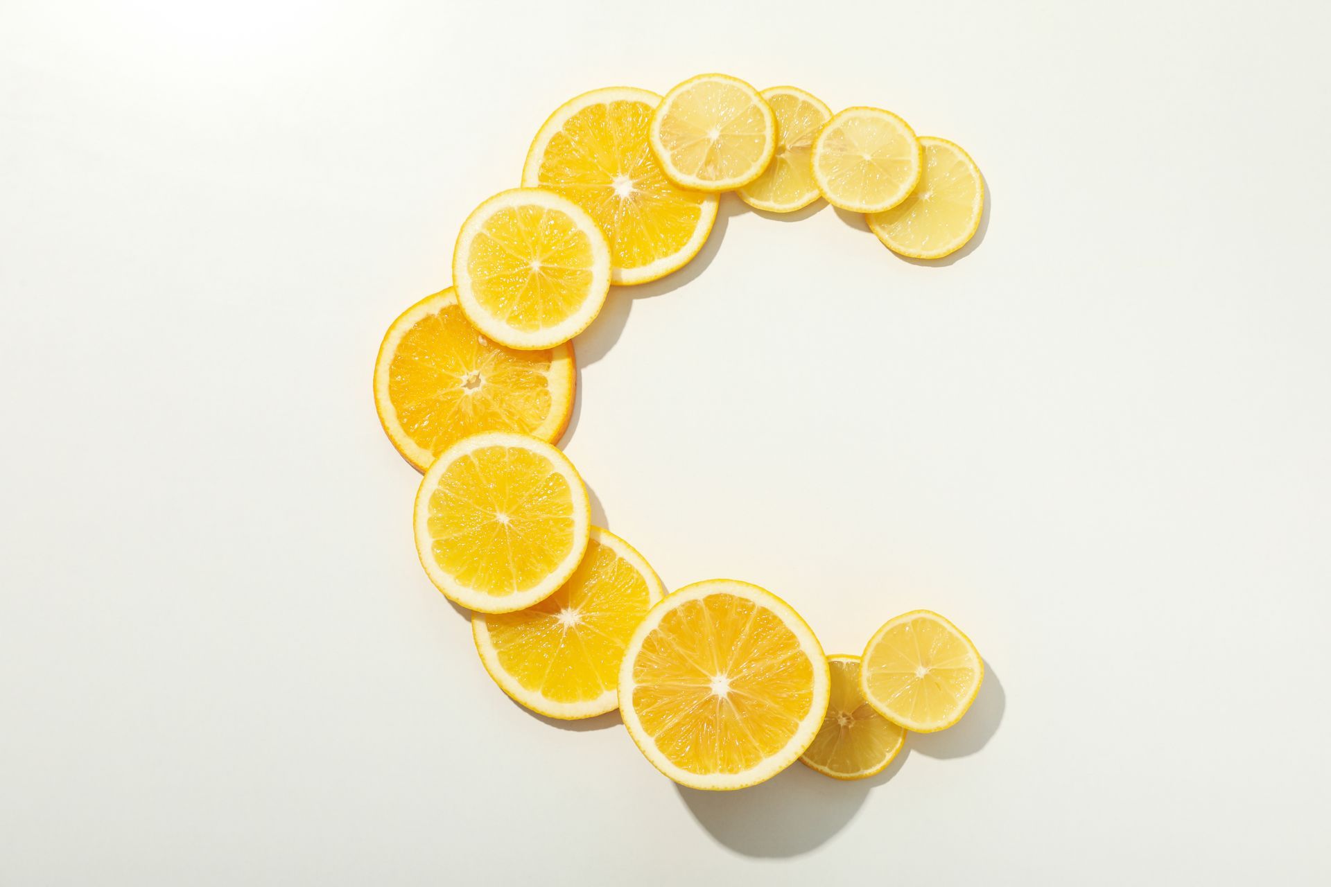 Slices of oranges and lemons arranged in the shape of the letter
