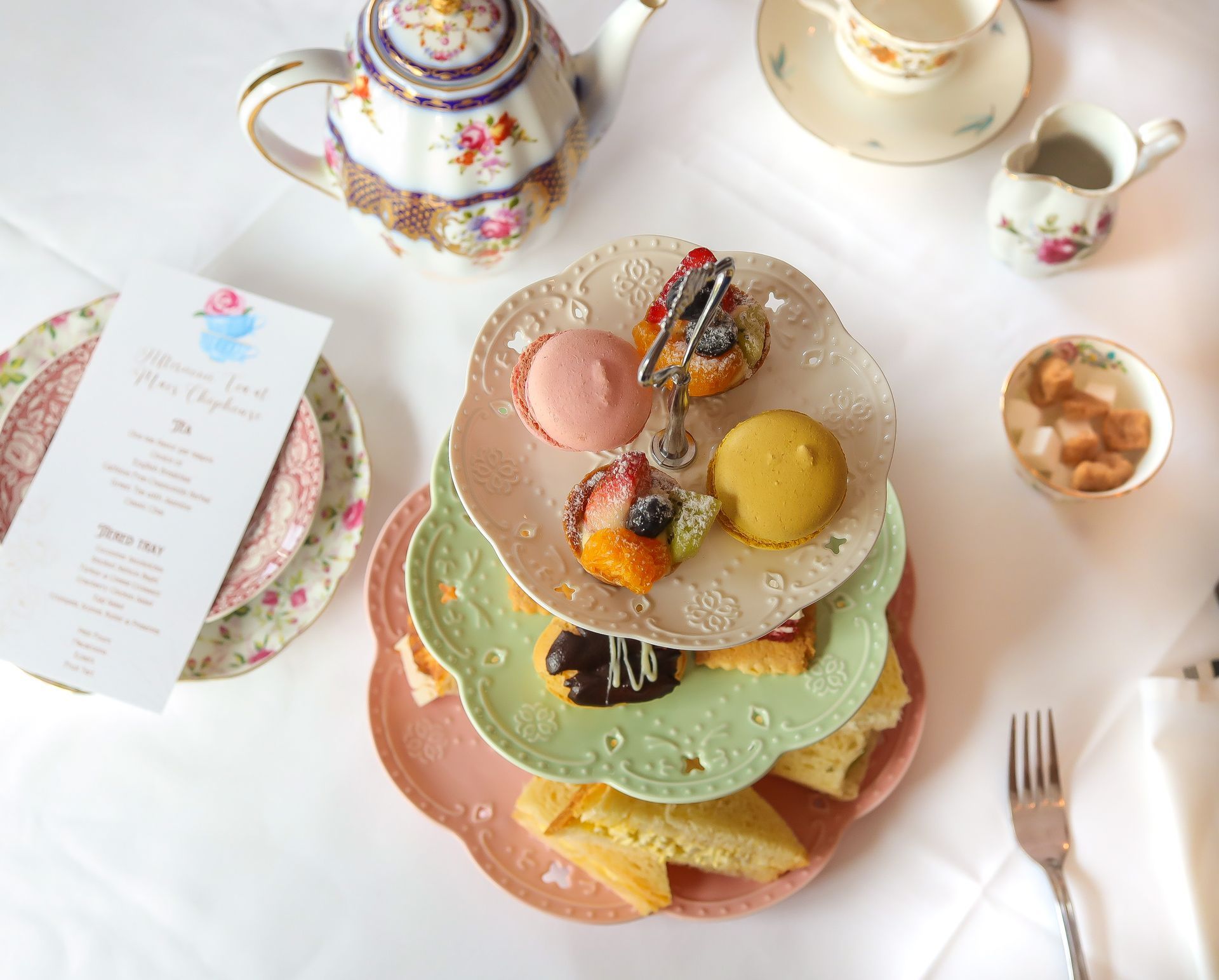 A table with plates of food and a menu on it