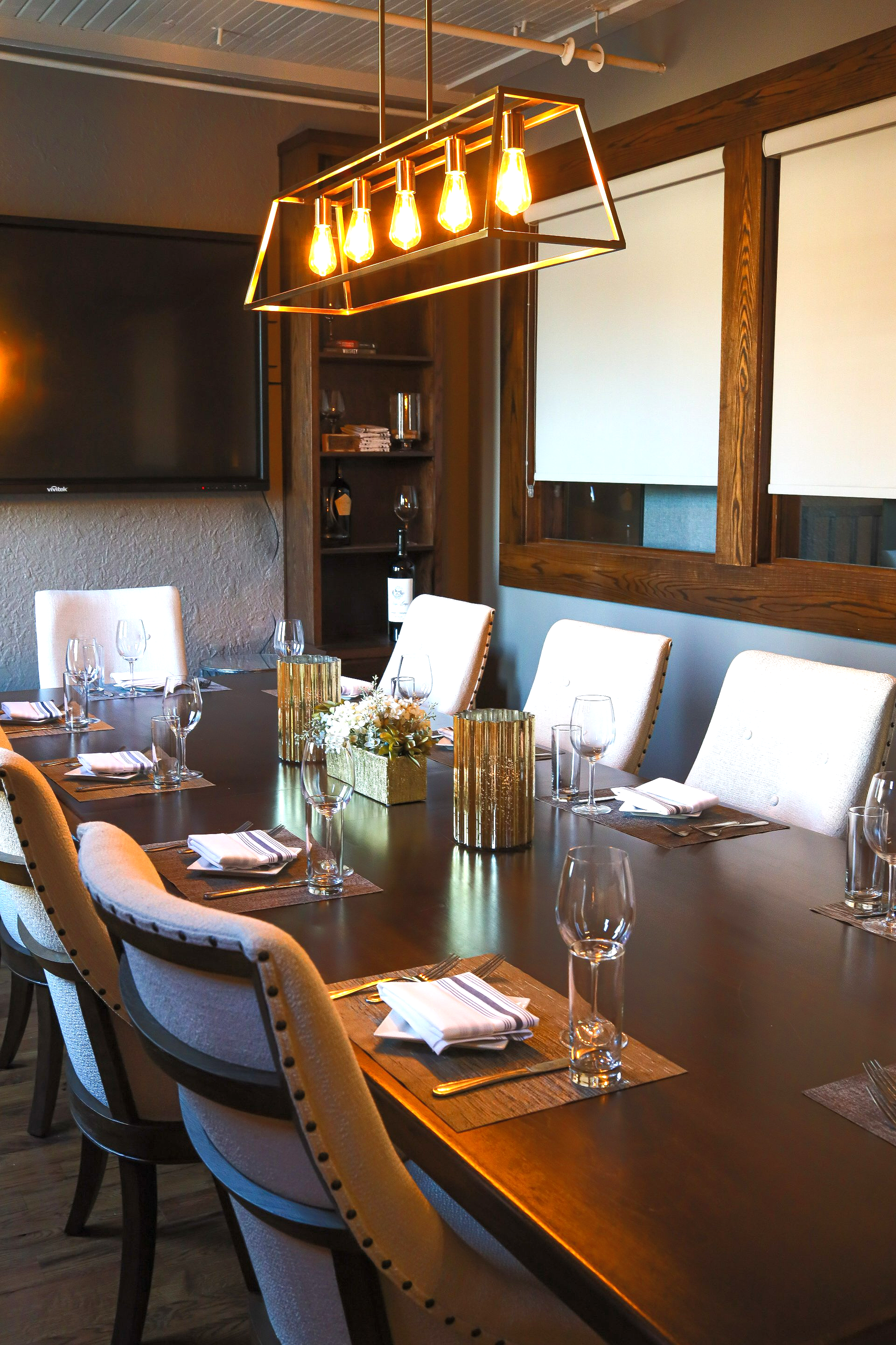 A conference room with a long table and chairs set for a meeting.