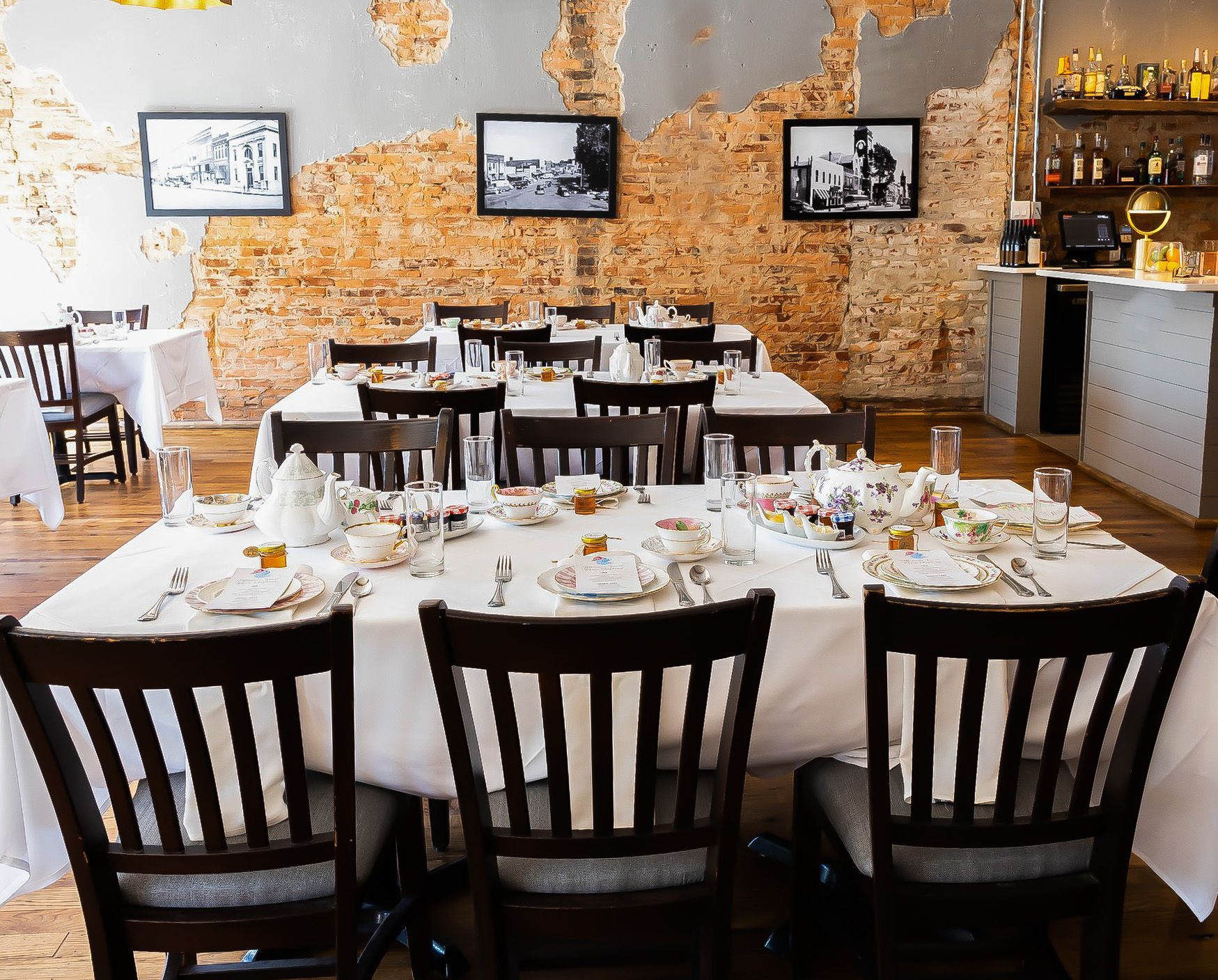 A restaurant with tables and chairs set up for a dinner party.