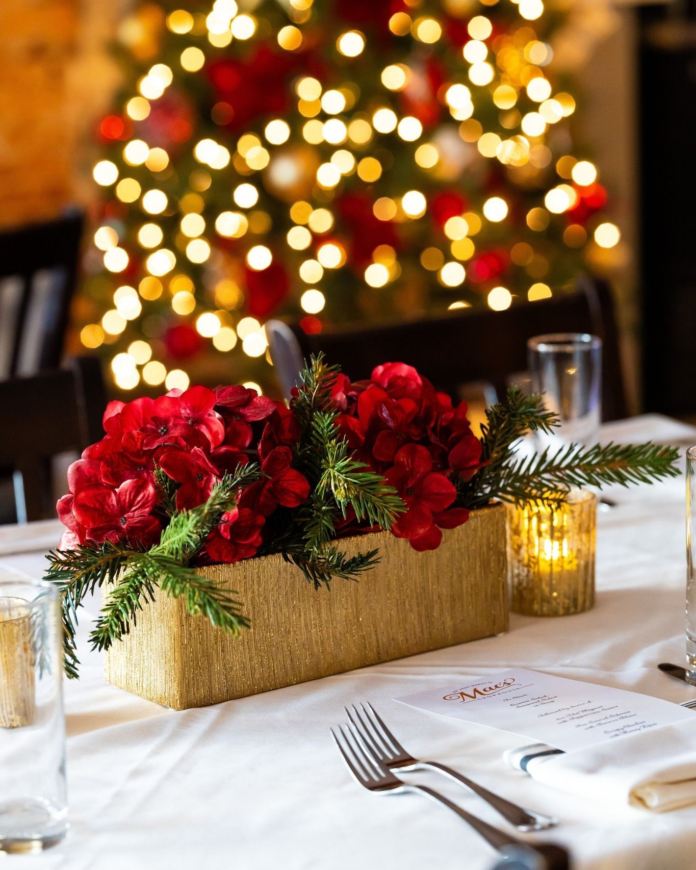 A table setting with a Christmas tree