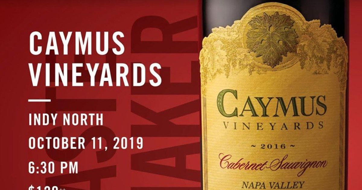 A bottle of caymus vineyards wine is on a red background