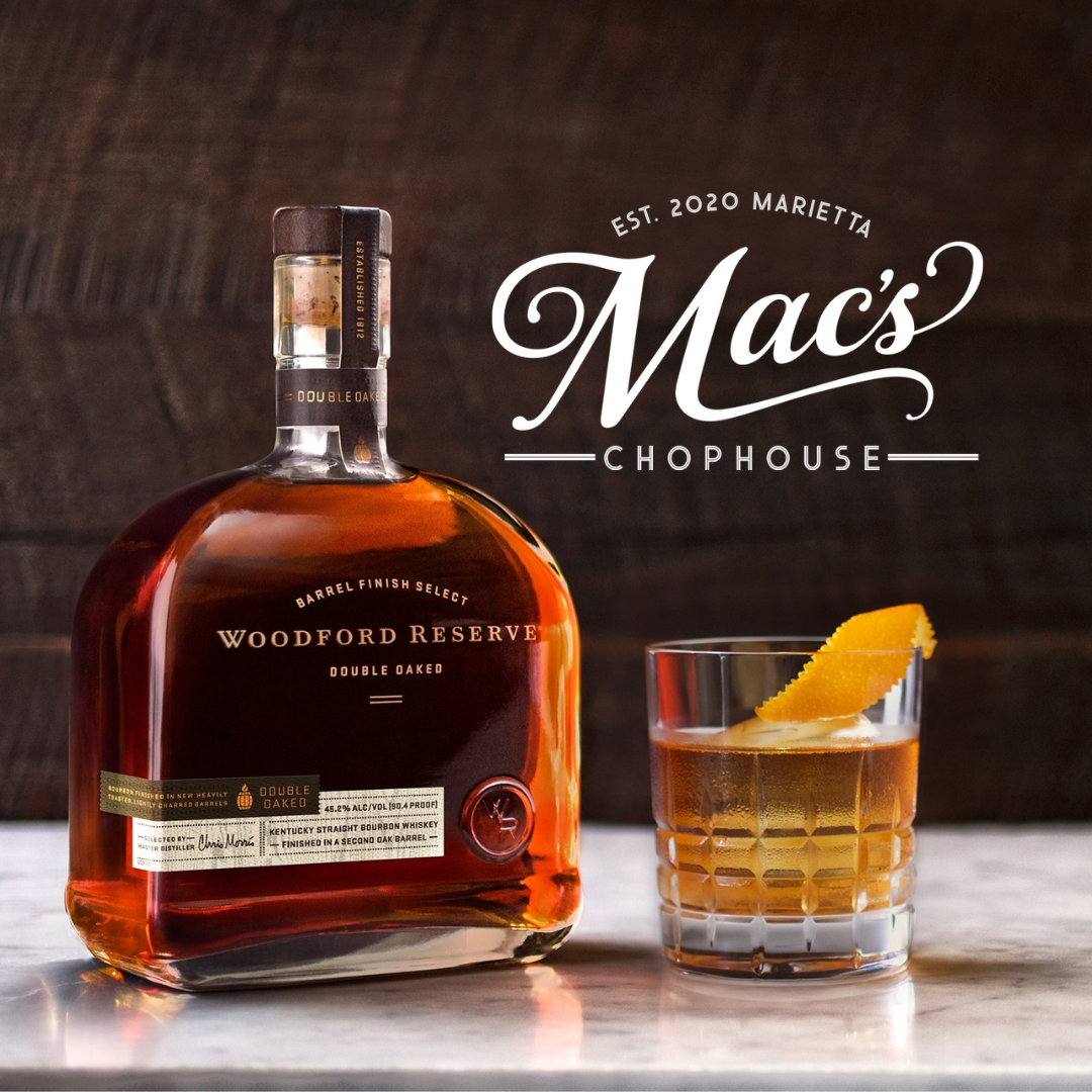 A bottle of woodford reserve next to a glass of whiskey