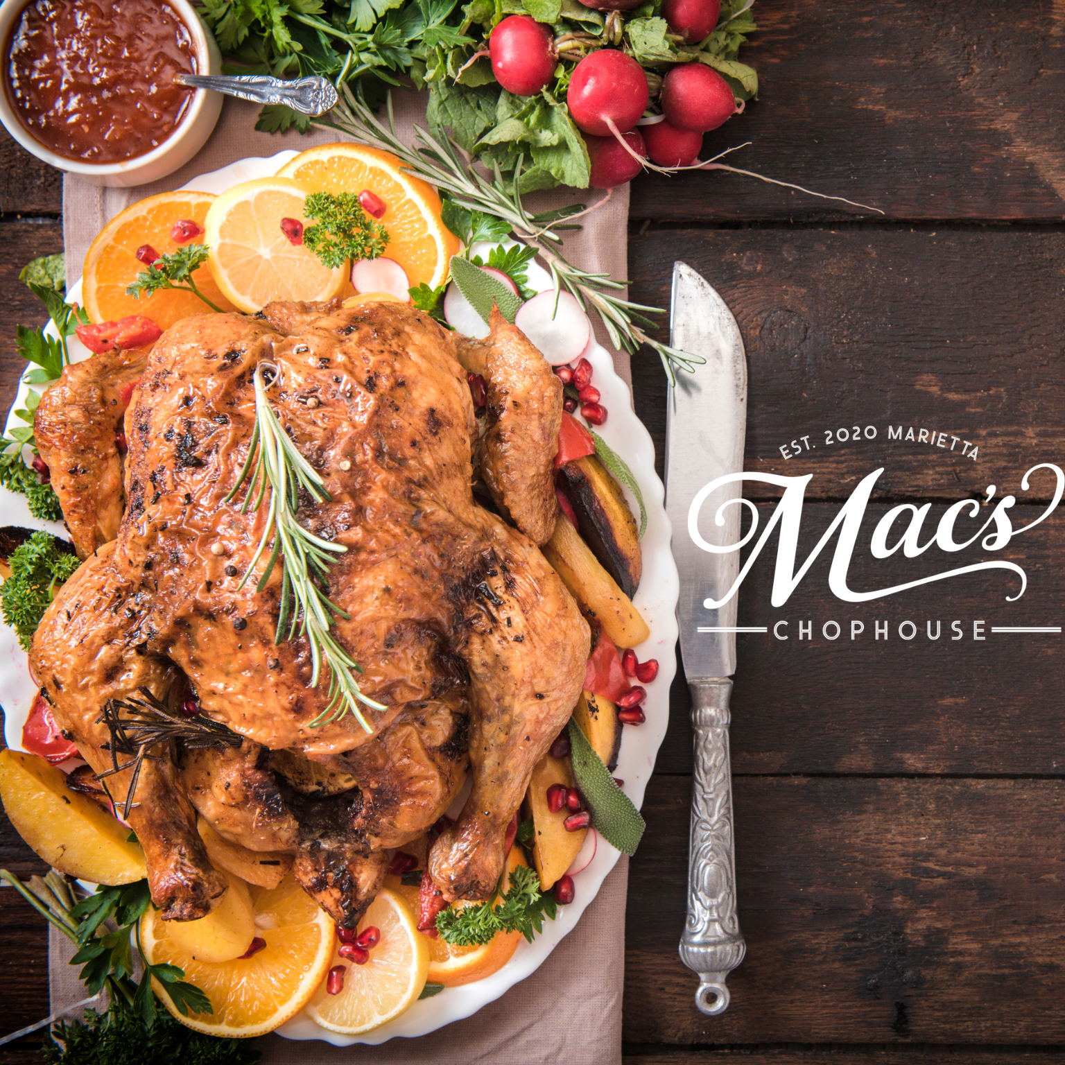 A plate of food from mac 's chophouse on a wooden table