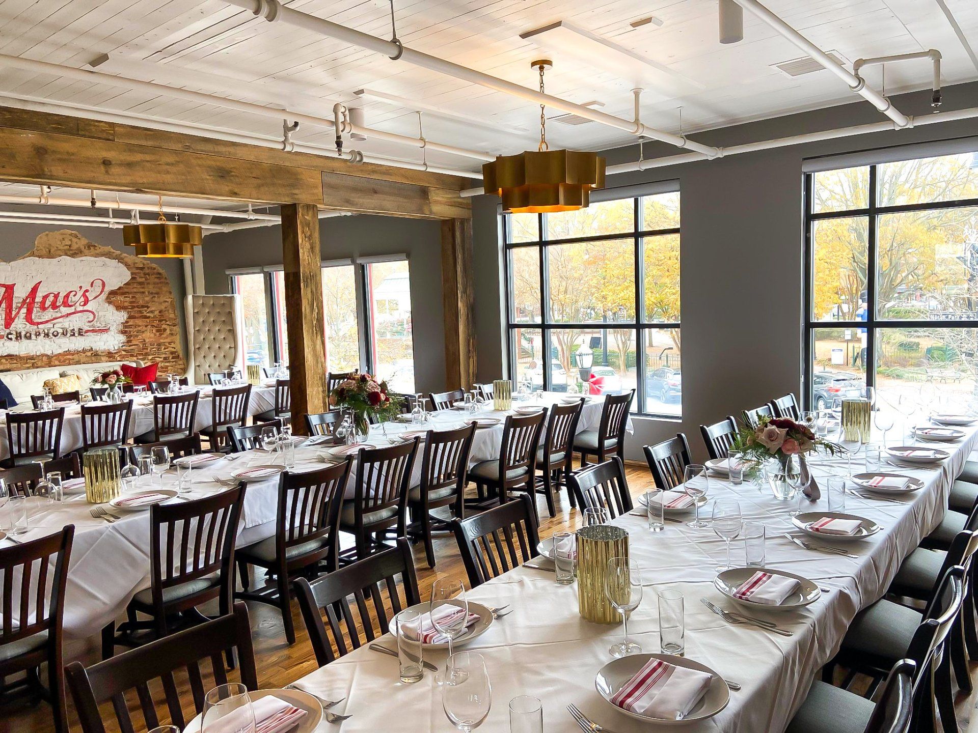 A large dining room with tables and chairs set up for a party.