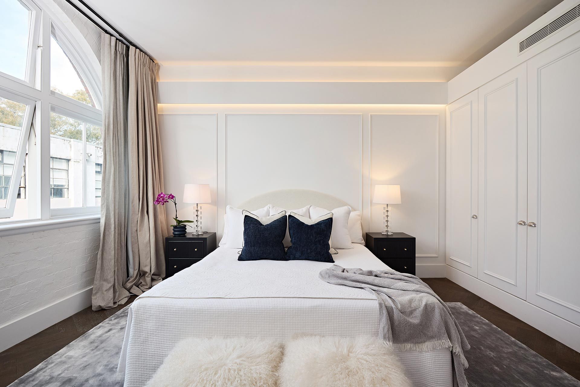 A bedroom with a large bed and two nightstands