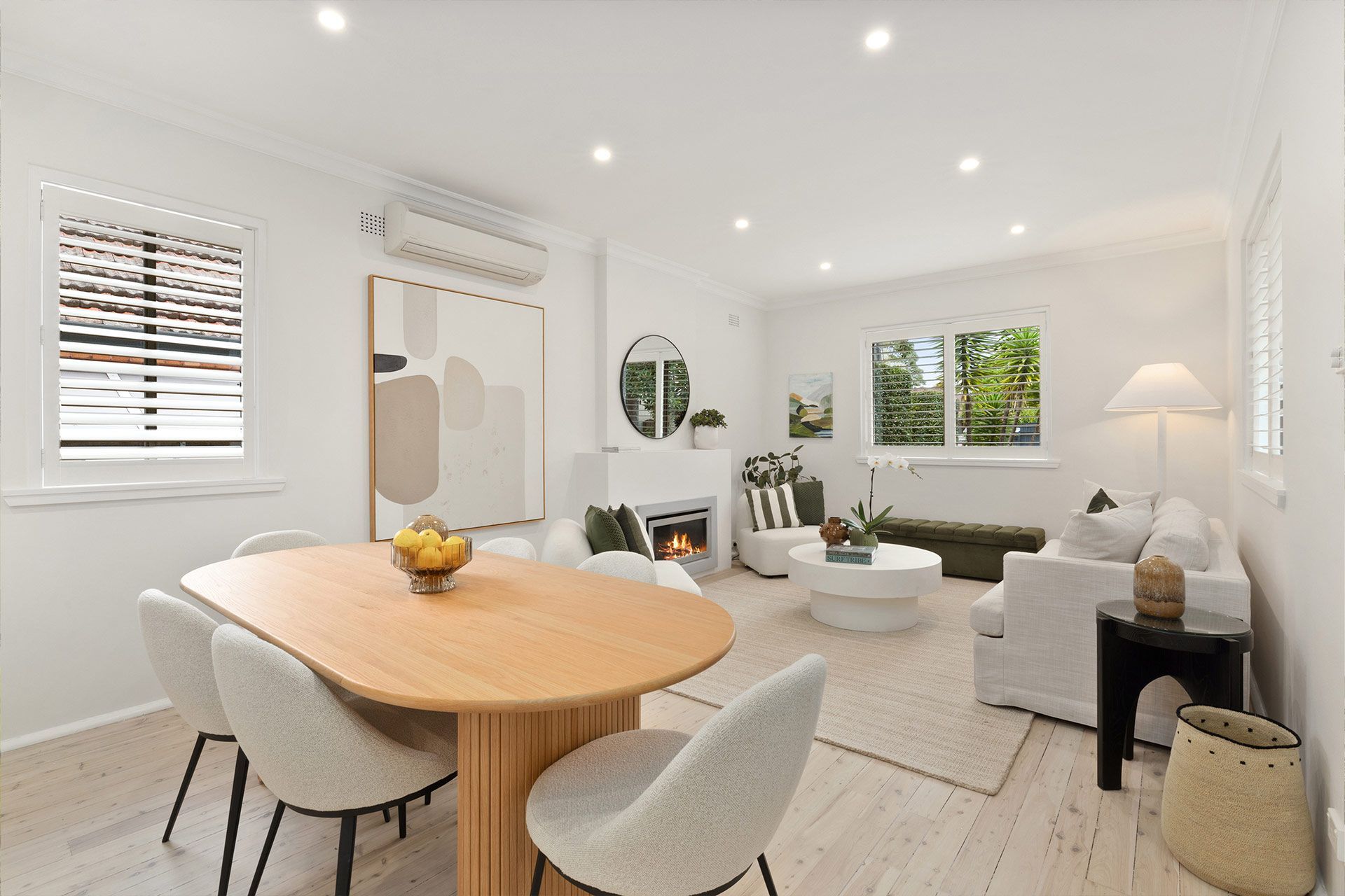 A living room with a table and chairs in it