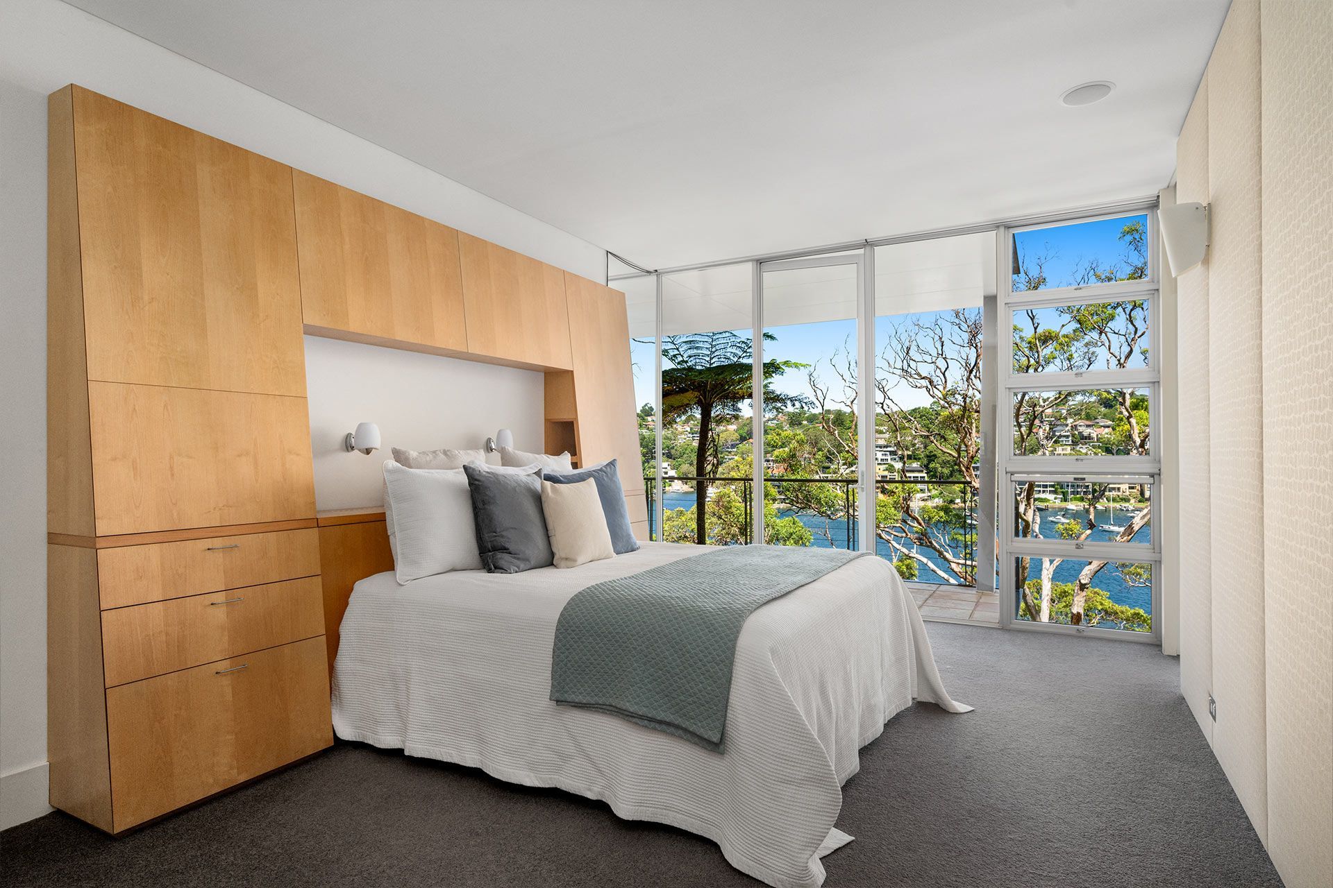 A bedroom with a large bed and a large window.