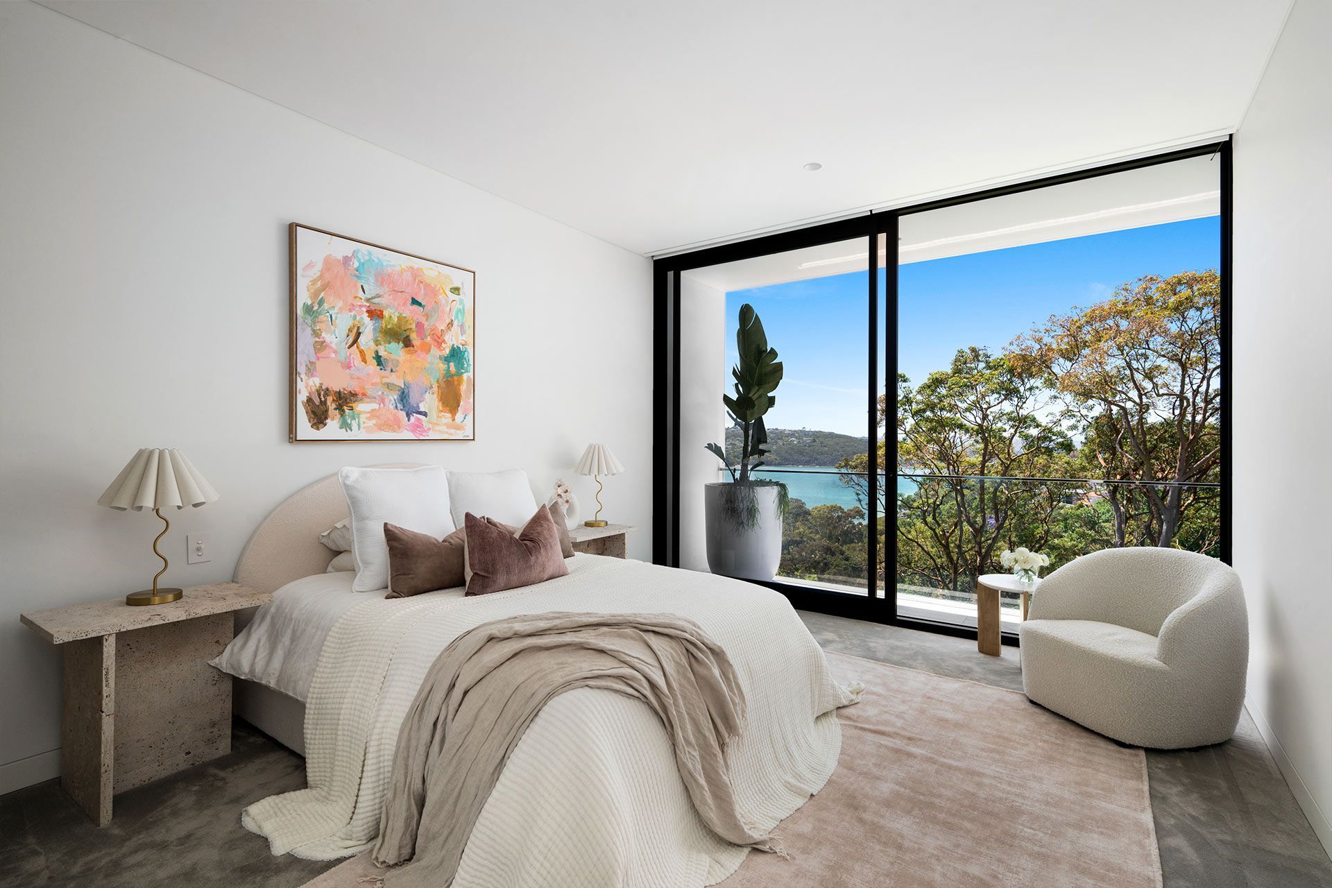 A bedroom with a large bed , chair and sliding glass doors.