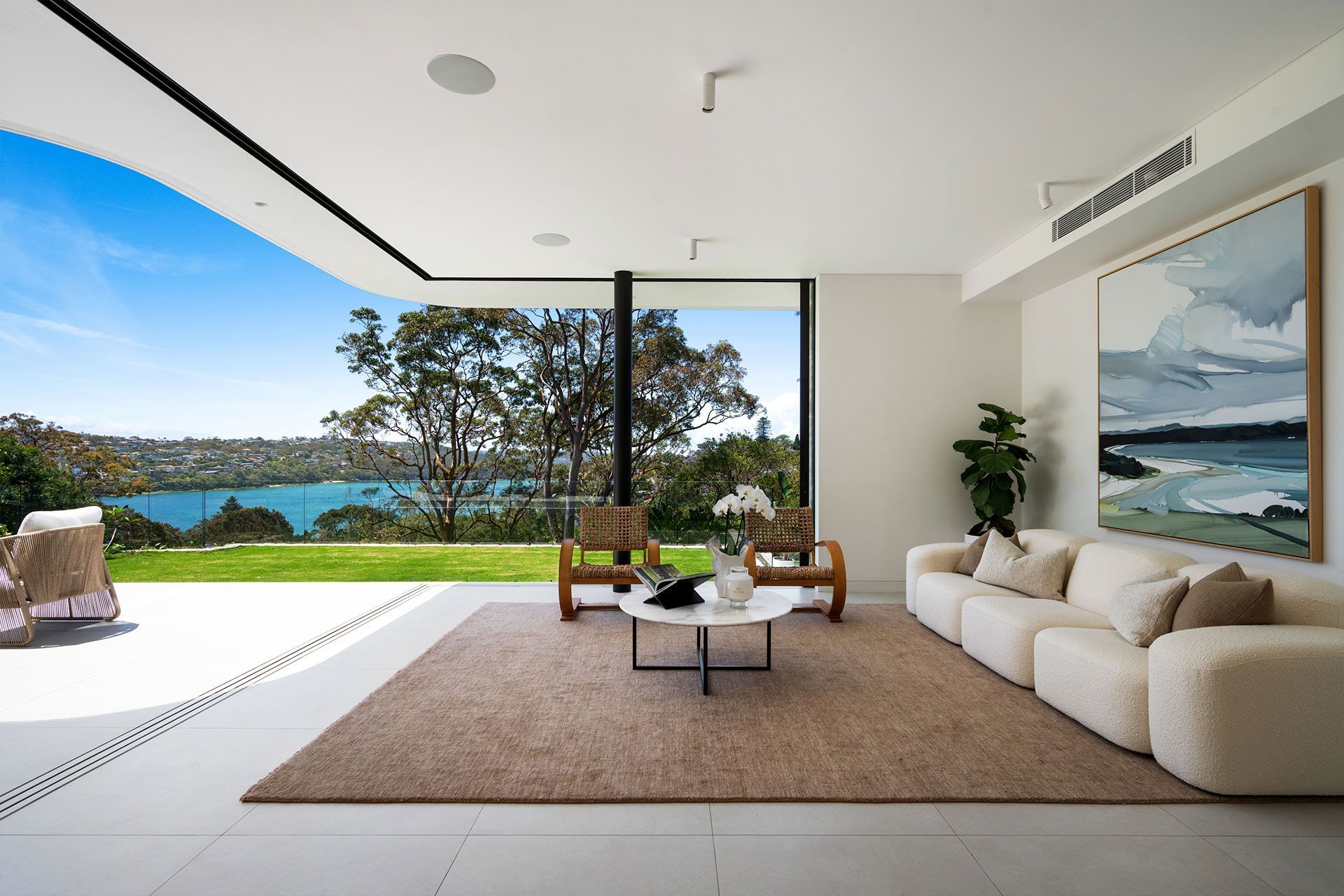A living room with a view of a lake and trees